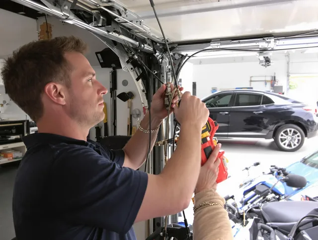 Kendale Lakes Garage Door Repair safety certified technician performing cable replacement in Kendale Lakes